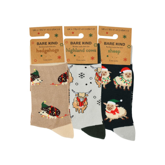 Three pairs of socks with animal designs on packaging labeled 'Bare Kind'.