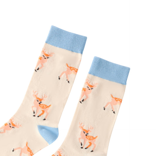 Pair of socks with deer pattern and blue cuffs on a white background