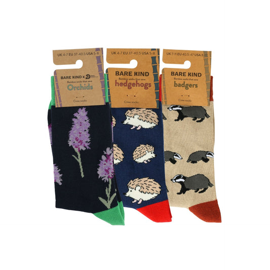 Three pairs of socks with animal and floral patterns on packaging labeled 'Bare Kind'.