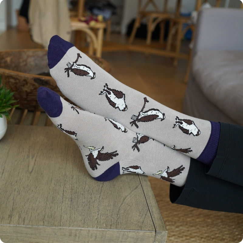 Pair of Osprey bamboo socks on a wooden surface