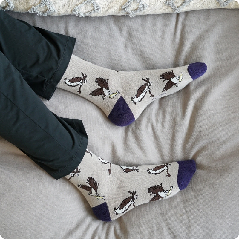 Pair of Osprey bamboo socks on a bed