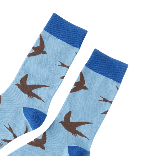 Light blue socks with brown swift pattern on a white background