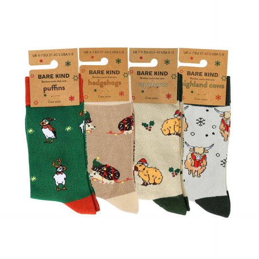 Four pairs of socks with animal designs in their packaging, featuring 'Bare Kind' branding.