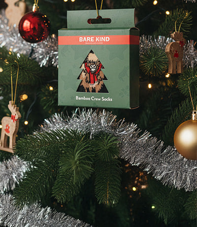 Christmas tree with ornaments and a Bare Kind gift box