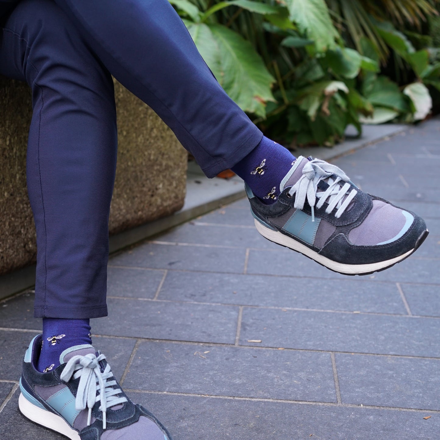 Model wearing Bare Kind bamboo socks, featuring small motifs of bees