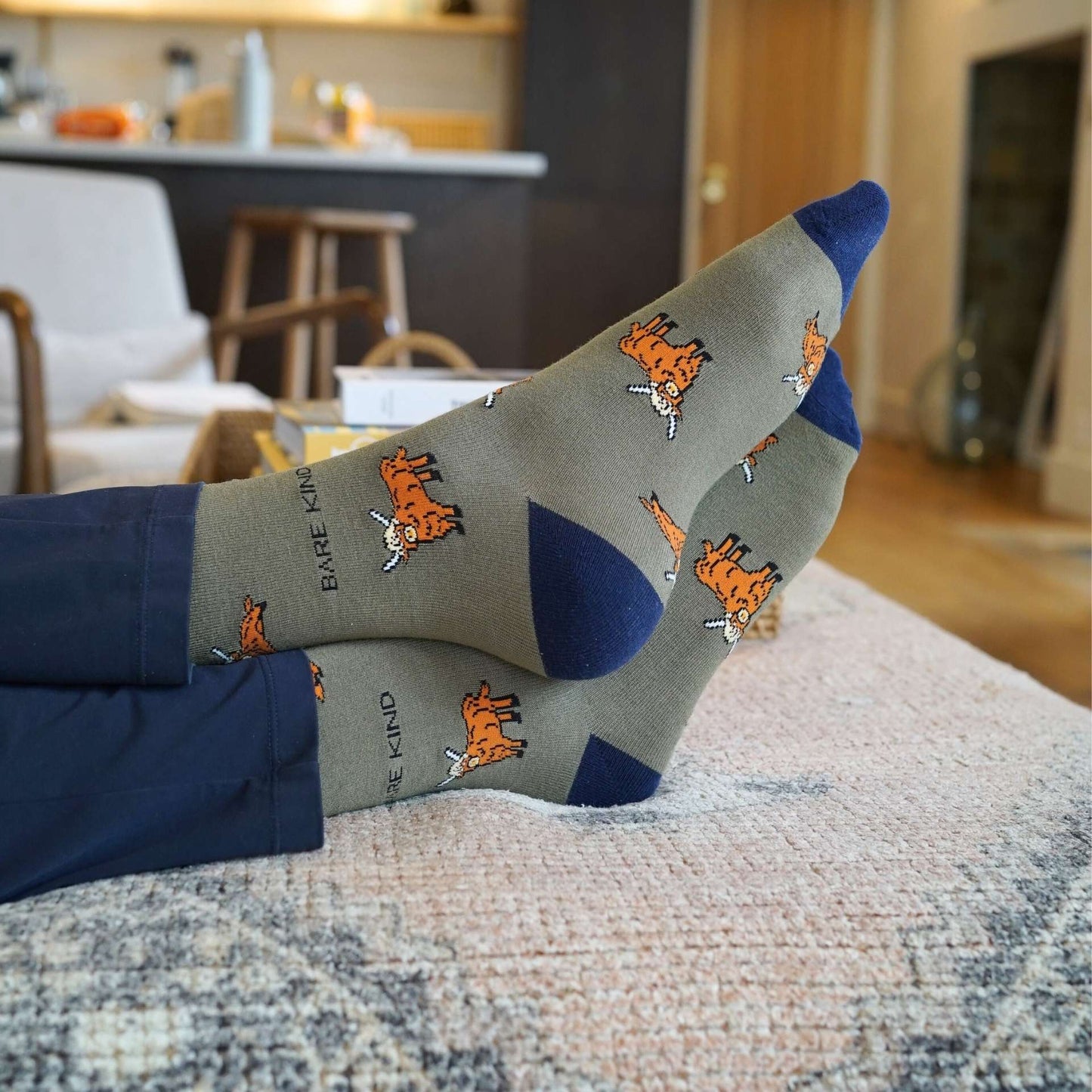 model wearing green highland cows bamboo socks