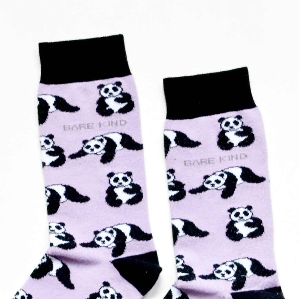 cuff closeup flat lay of lilac and black panda socks