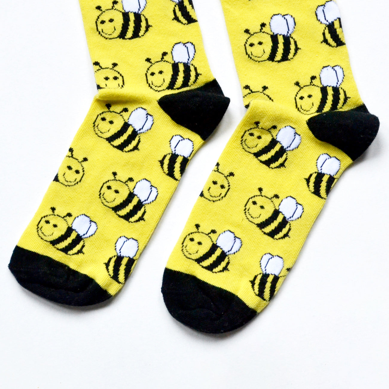 toe closeup flat lay of black and yellow bee bamboo socks