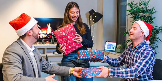 work mates giving Christmas gifts each other