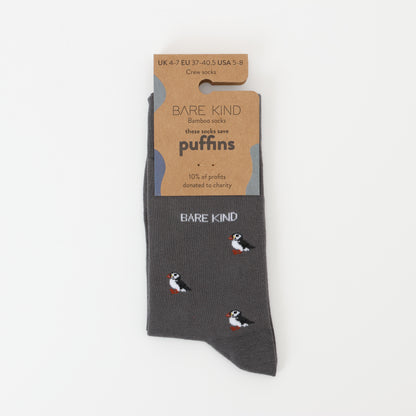 Flat lay of Bare Kind bamboo socks packaging, featuring small motifs of puffins