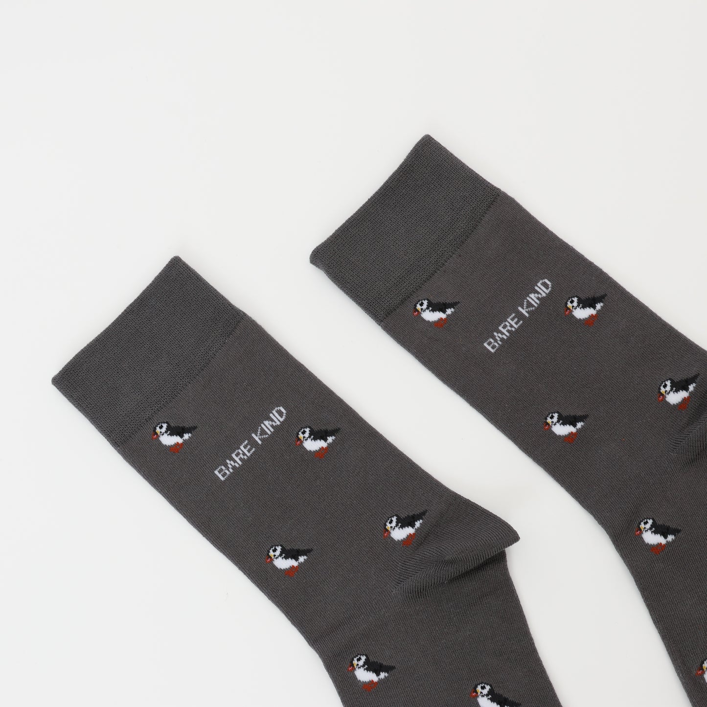 Close up to Bare Kind bamboo socks packaging, featuring small motifs of puffins