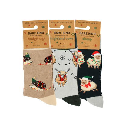 Three pairs of socks with animal designs on packaging labeled 'Bare Kind'.