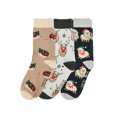 Three pairs of socks with festive animal patterns on a white background