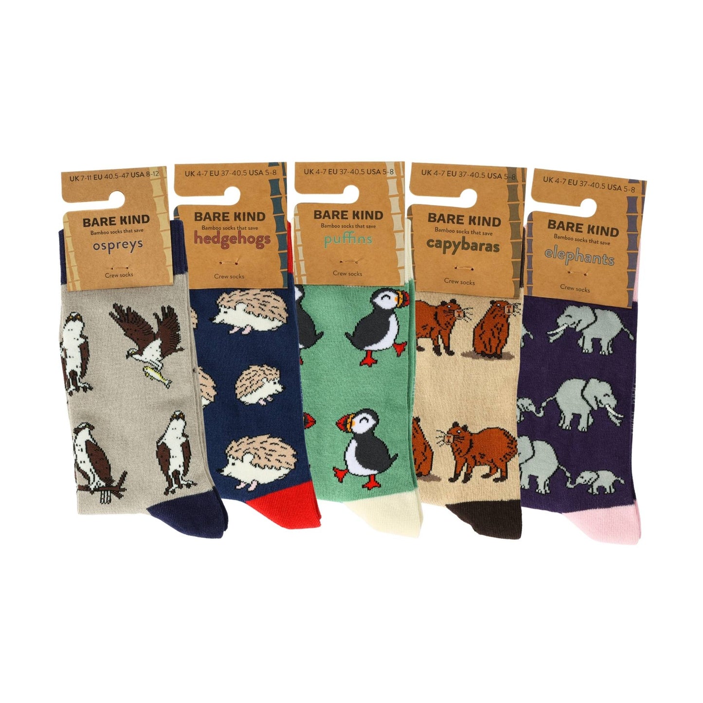 Five pairs of animal-themed socks in their packaging on a white background