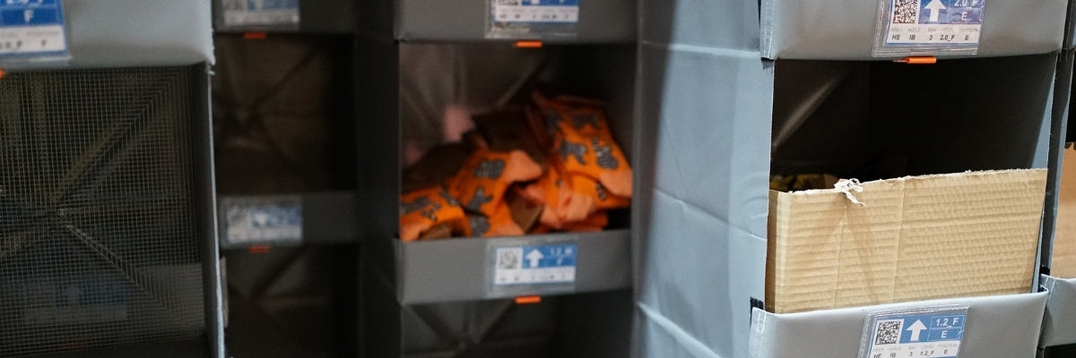 Stacked boxes in a storage area with labels on the sides.
