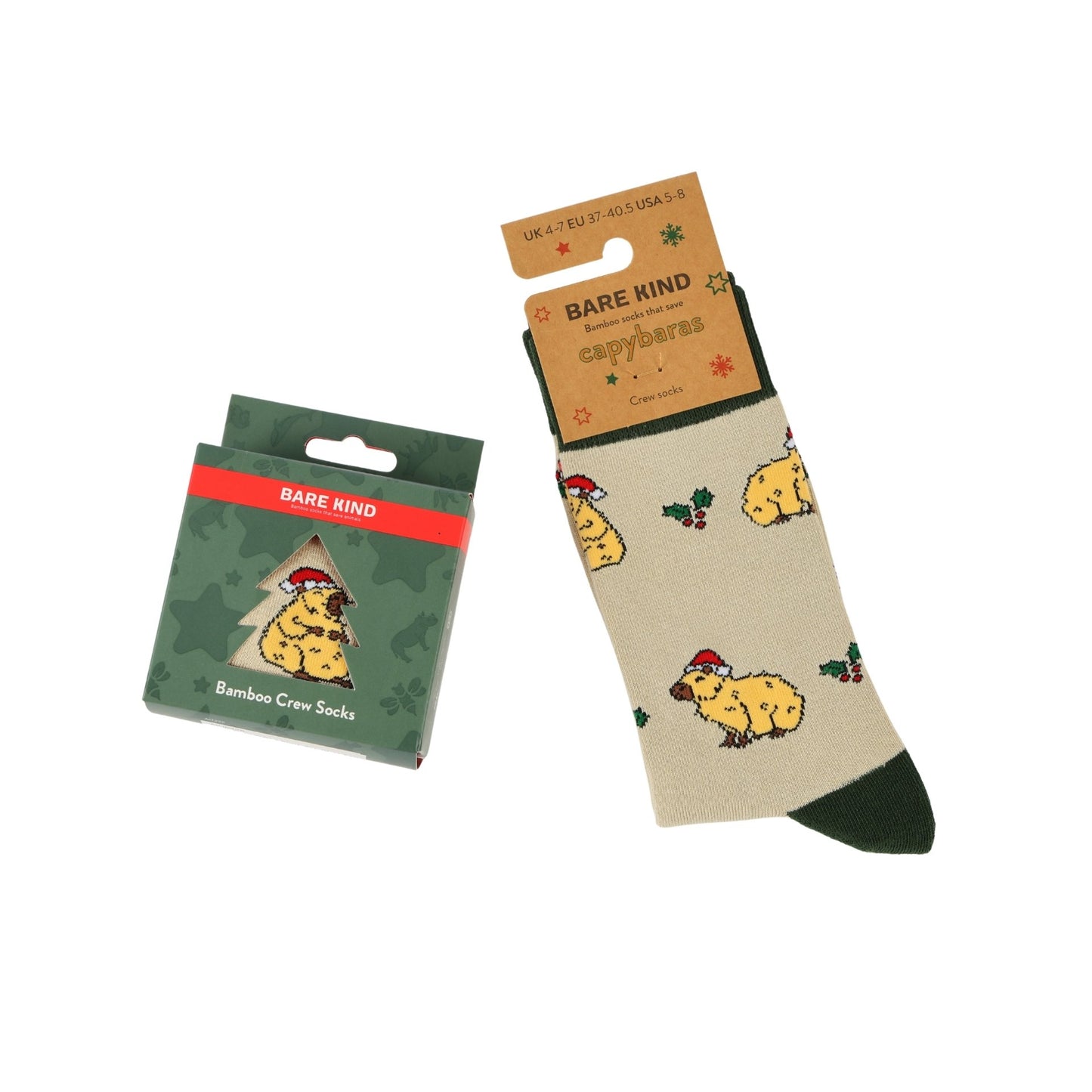 Bare Mind capybara-themed bamboo crew socks shown both in their green retail packaging and unpacked. The socks feature a beige body with a yellow capybara wearing a red Santa hat, green cuffs and toes, and small red holly accents.