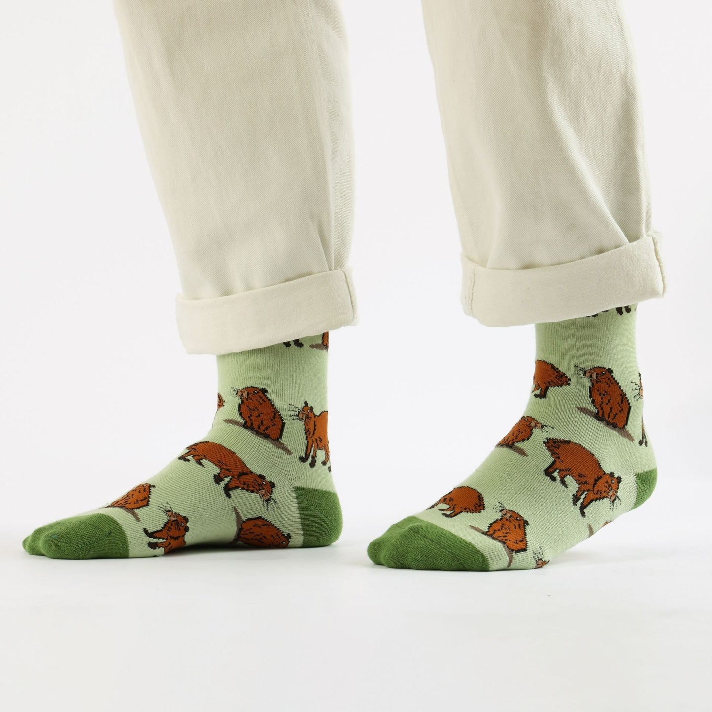 Green capybara bamboo sock worn by a person on a white background