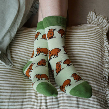 Person wearing green capybara bamboo socks