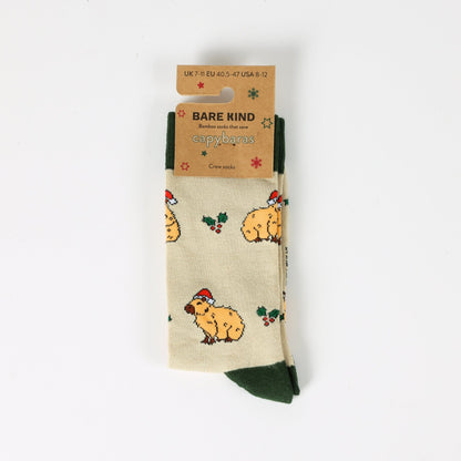 Beige socks with capybara pattern and 'Bare Kind' packaging on a white background