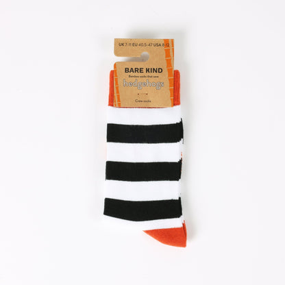 Black and white striped socks with orange accents on a white background, featuring 'Bare Kind' packaging.