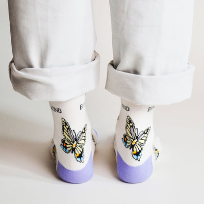 rear view of standing model wearing bamboo socks featuring butterfly design