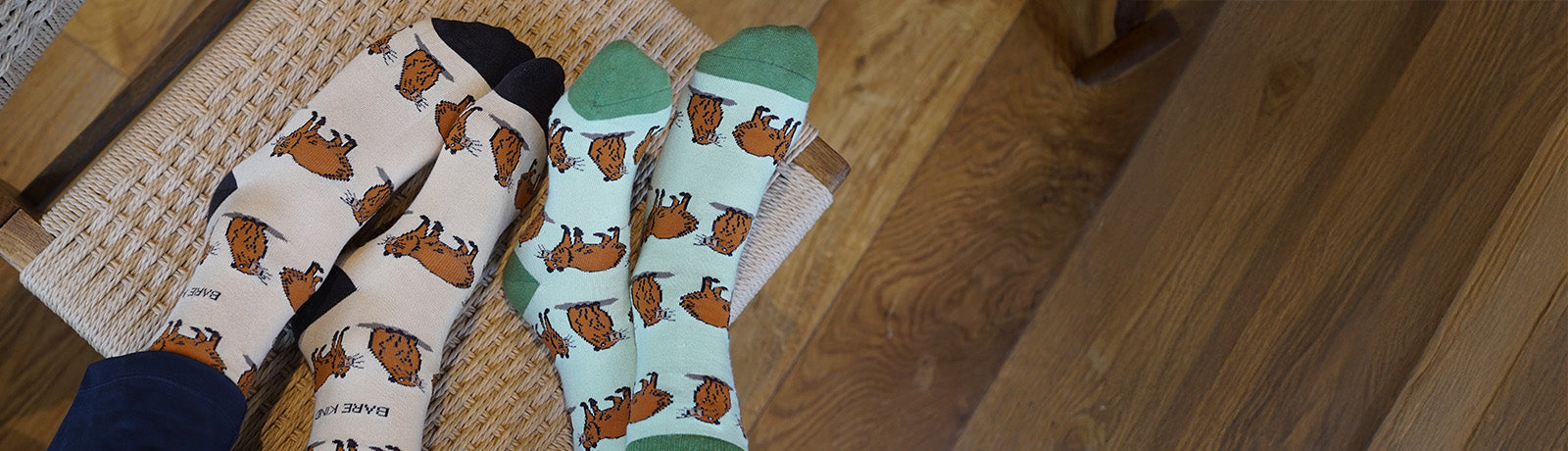 Two people wearing green and brown capybara socks