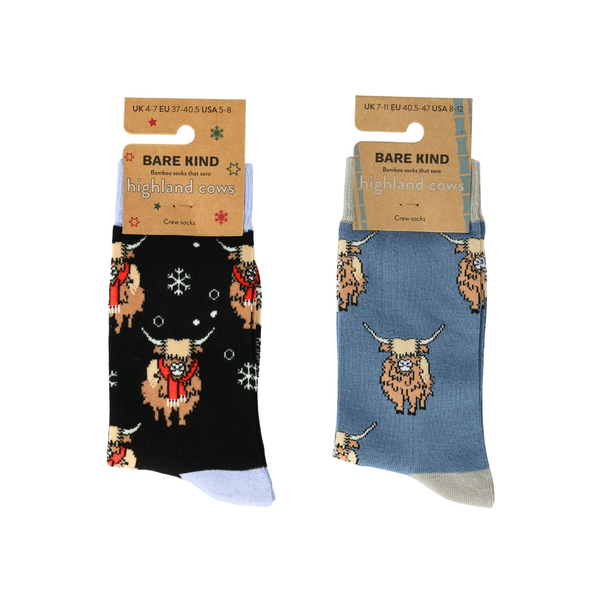 Two pairs of Bare Kind highland cows crew socks on a white background. One pair is black with tan highland cows wearing red scarves and white snowflakes, and the other pair is dusty blue with tan highland cows and light blue heels.