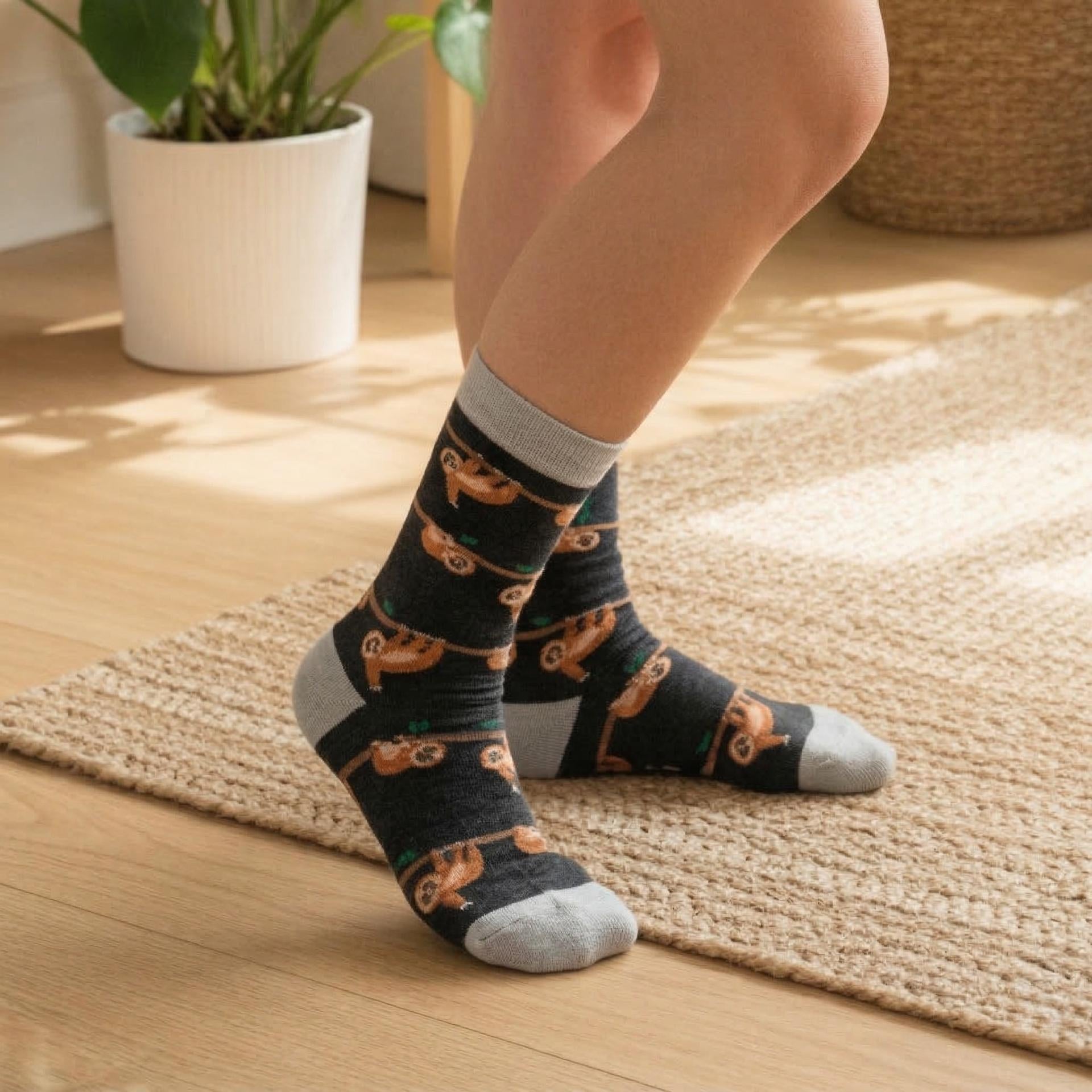 Person wearing black slow loris socks on a wooden floor