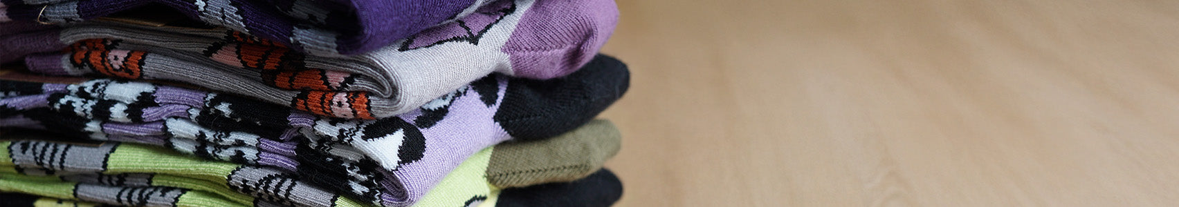 Stack of colorful socks on a wooden surface