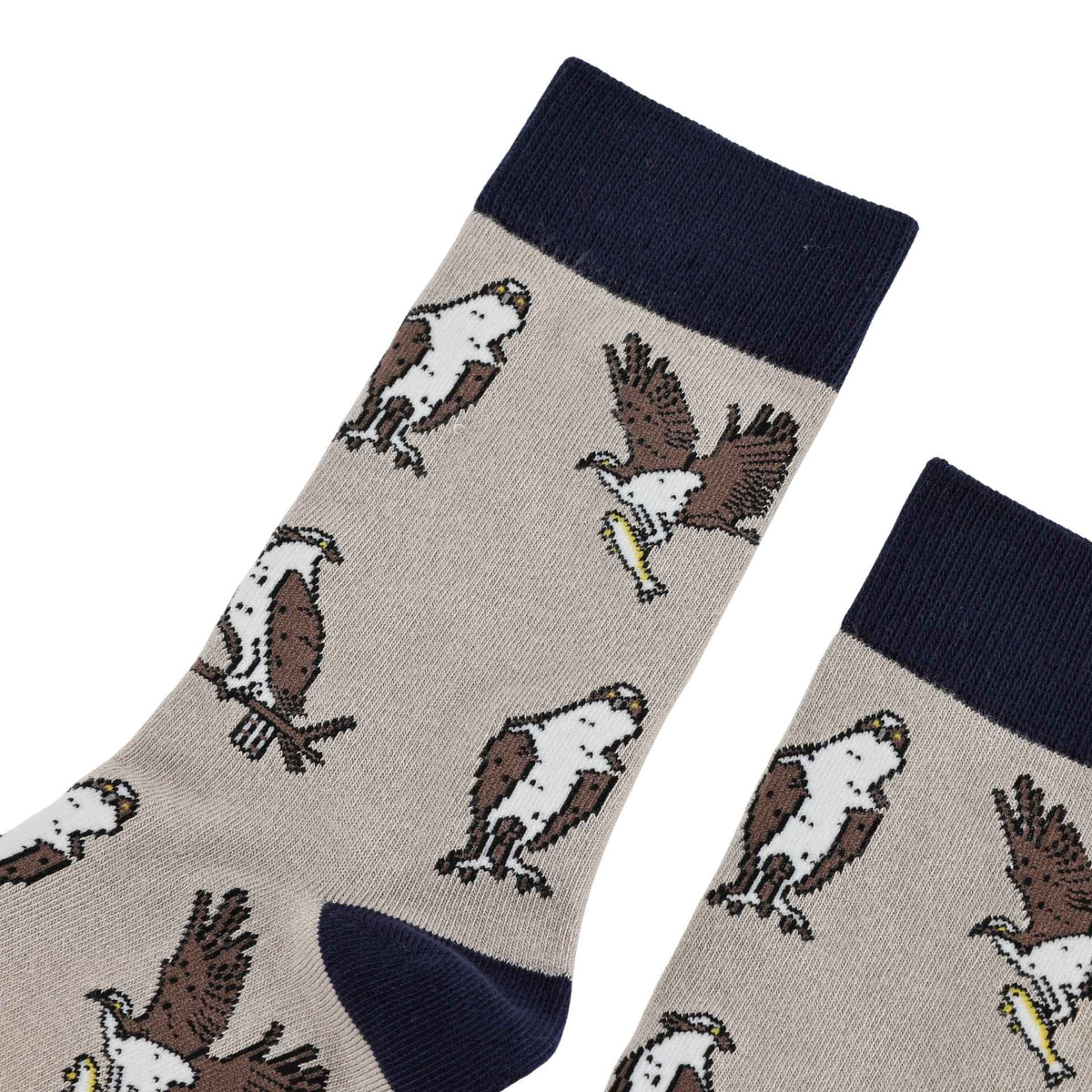 A pair of crew socks with a beige body featuring a repeating pattern of brown and white ospreys, finished with a navy blue ribbed cuff, navy toe, and navy heel.