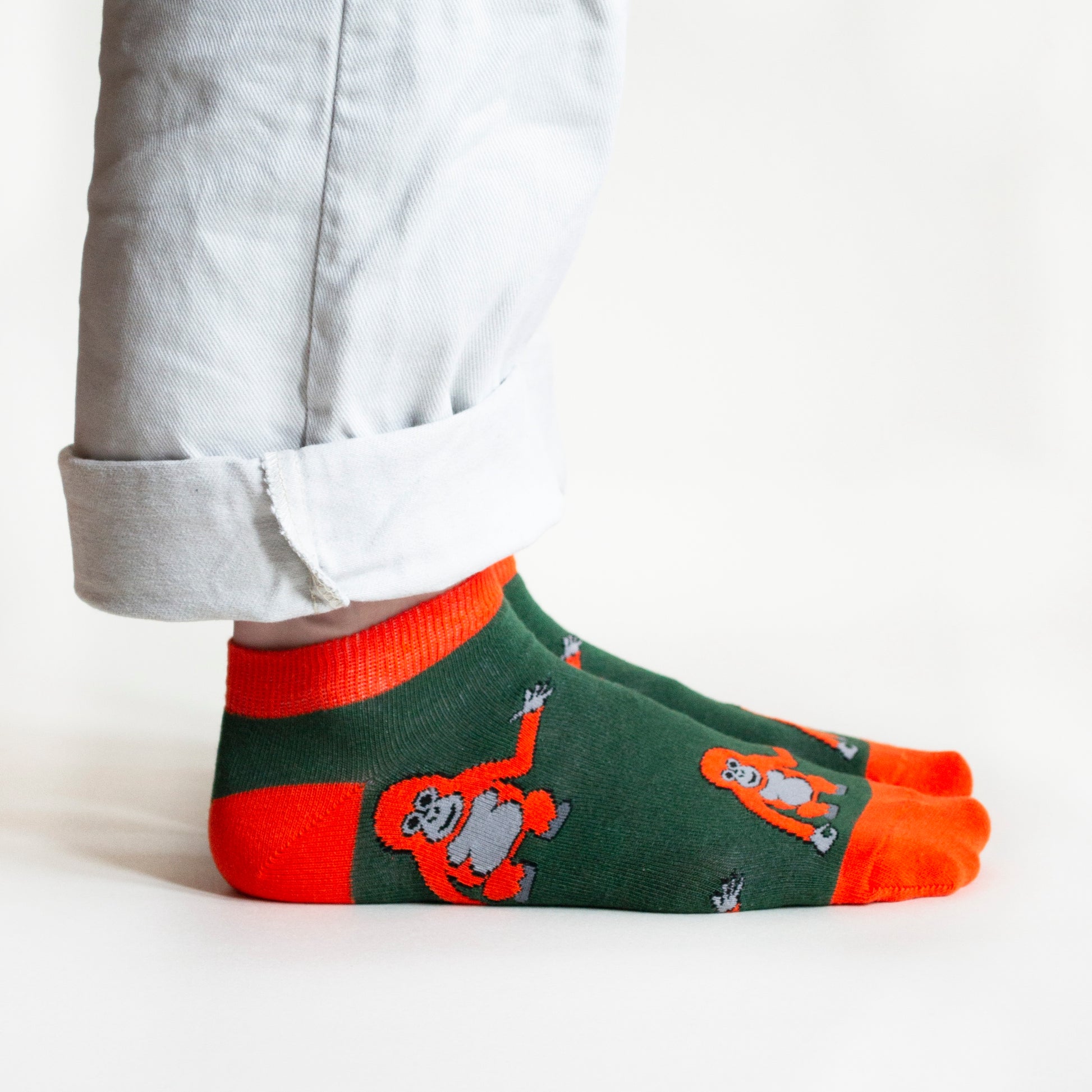 side profile of standing model wearing bamboo trainer socks featuring orangutan design