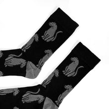 cuff closeup flat lay of soft top black panther crew socks for adults