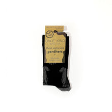 folded flat lay of soft top black panther crew socks for adults in 100% recyclable cardboard packaging