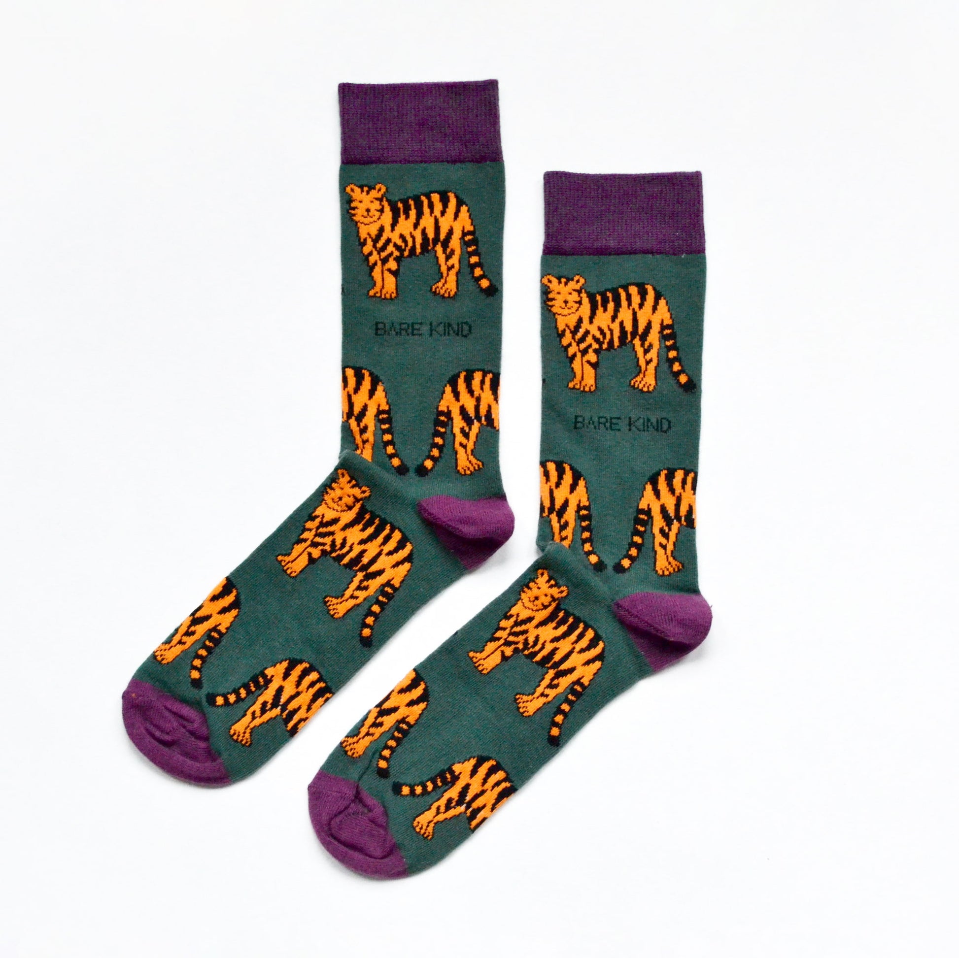 Flat lay of green tiger bamboo socks with purple cuff