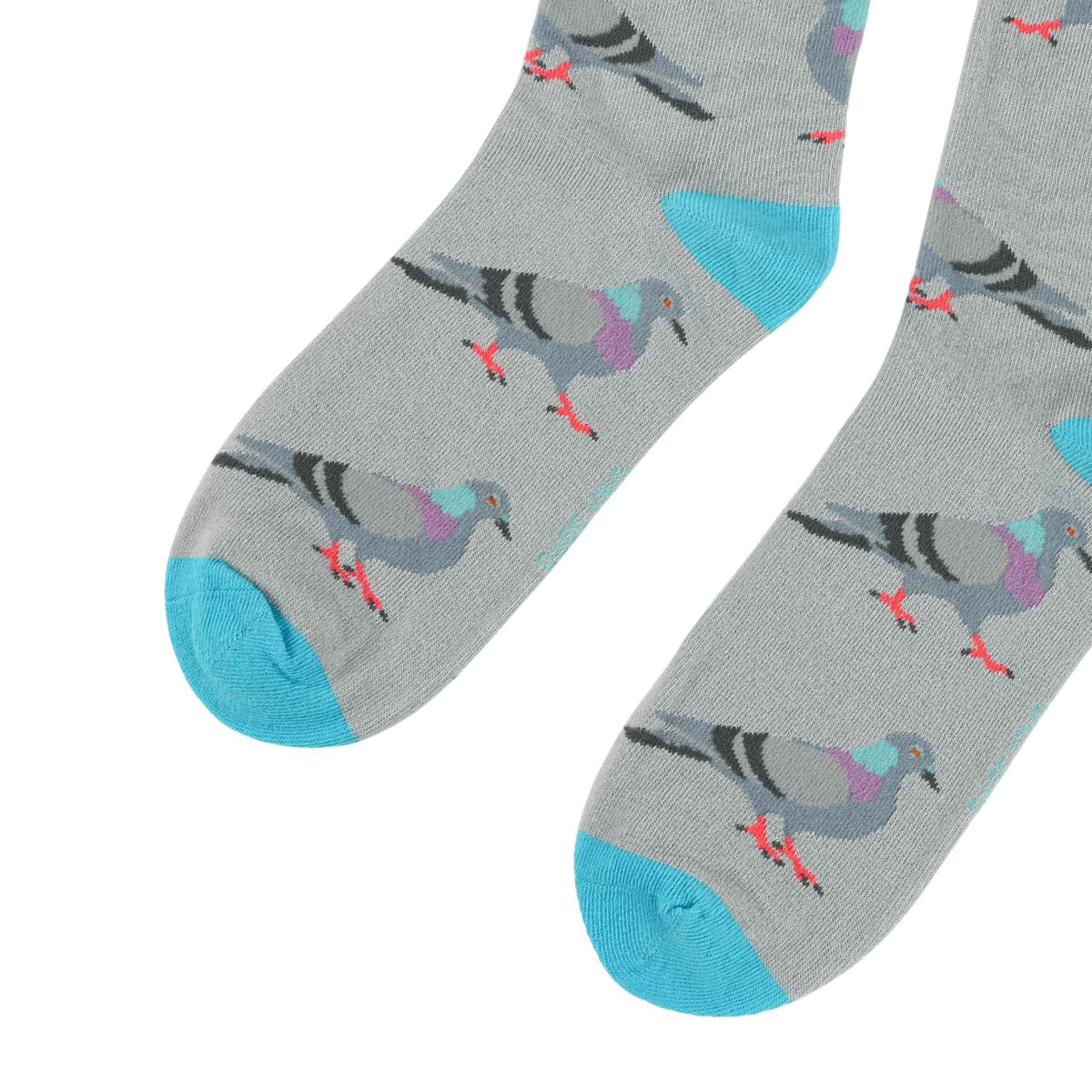 A pair of gray crew socks with a repeating pattern of pigeons in shades of gray, black, purple, and blue, finished with bright blue toes and heels, shown on a plain white background.