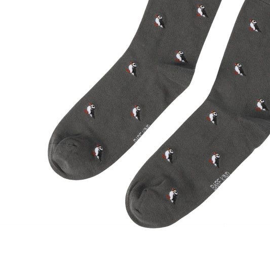 Dark gray socks with puffin pattern on a white background