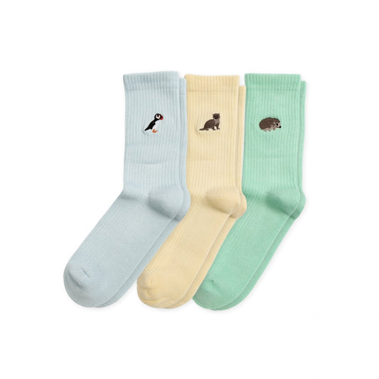 flat lays of ribbed yellow otter, blue puffin, and green hedgehog bamboo socks