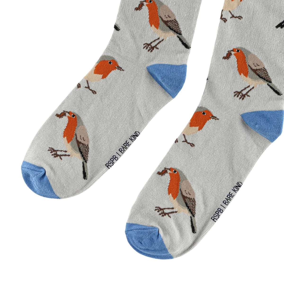 A pair of light gray crew socks with a repeating pattern of robin birds and blue toes, heels, and soles. The brand name 'RSPB RARE KIND' is printed vertically near the foot.