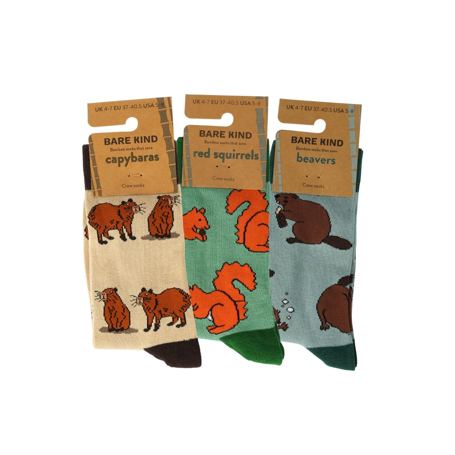 Three pairs of socks with animal illustrations on packaging labeled 'Bare Kind'.
