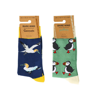Two pairs of Bare Kind Gannets and puffins crew socks displayed side-by-side on their cardboard hangers against a plain white background.