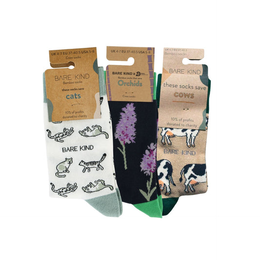 Three pairs of socks with packaging displaying animal illustrations and 'Bare Kind' branding.