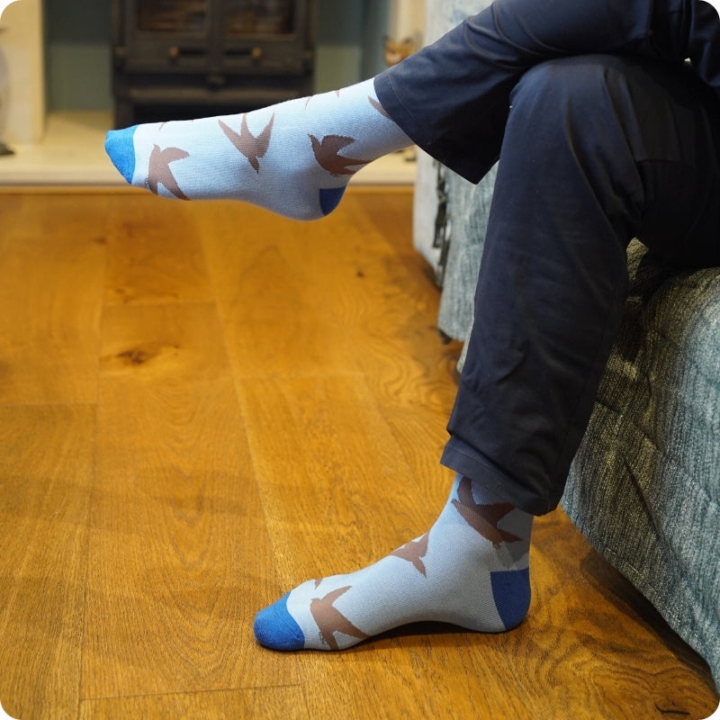 Person wearing swift socks on a wooden floor