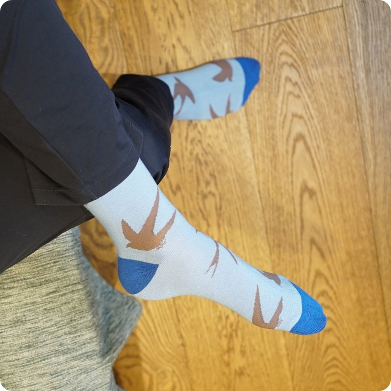 Person wearing swift socks on a wooden floor