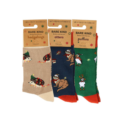 Three pairs of socks with animal illustrations on a white background, each in a separate packaging sleeve.