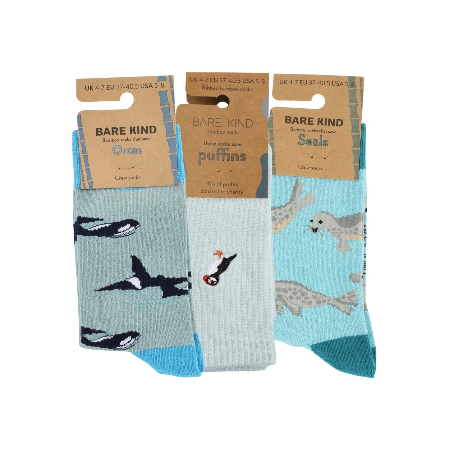 Three pairs of socks with animal designs on packaging labeled 'Bare Kind'.