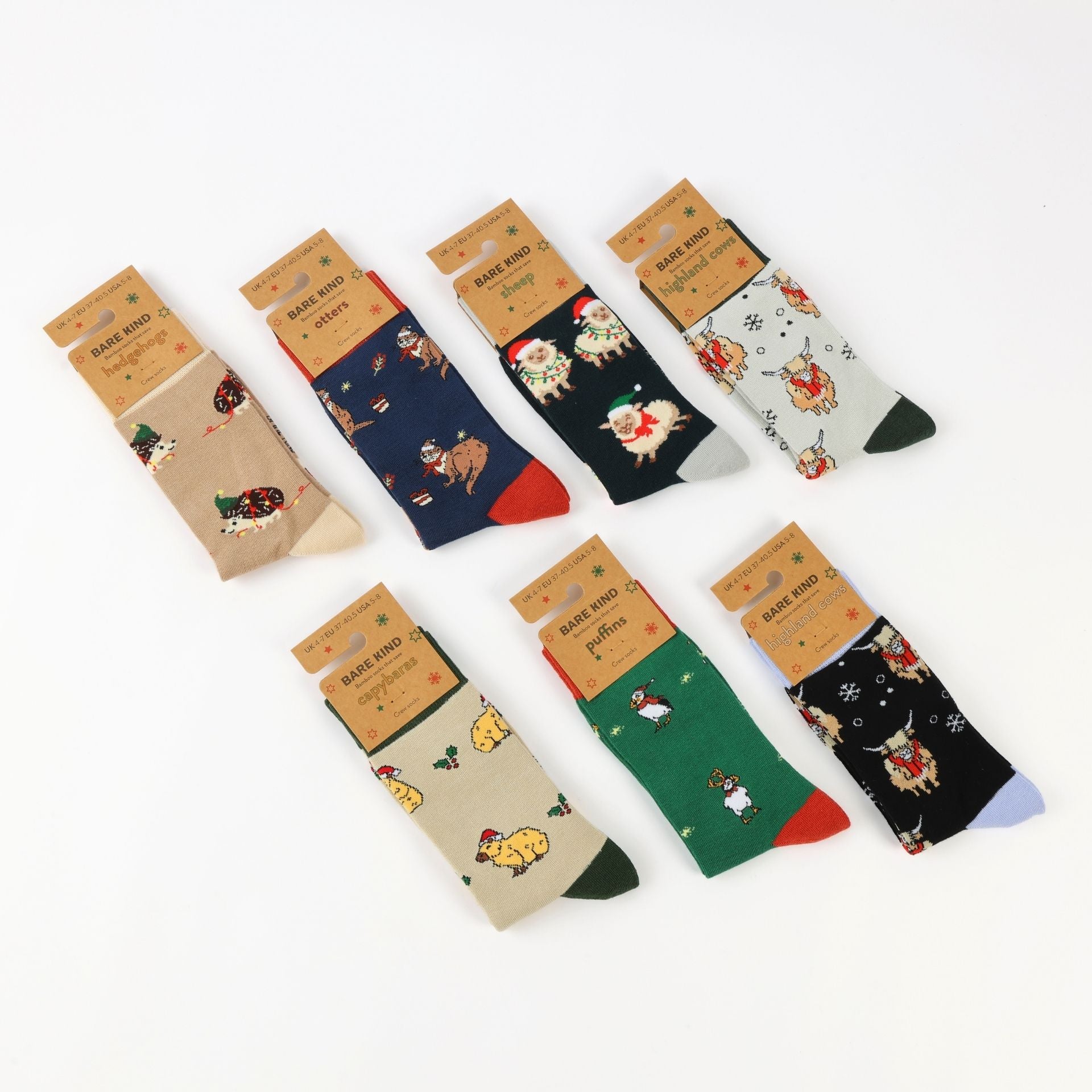 Six pairs of Christmas-themed crew socks displayed on a clean white background. The socks feature various holiday illustrations.