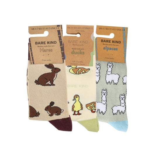 Three pairs of Bare Kind socks with animal illustrations on packaging