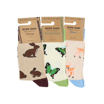 Three pairs of socks with animal designs and 'Bare Kind' packaging on a white background