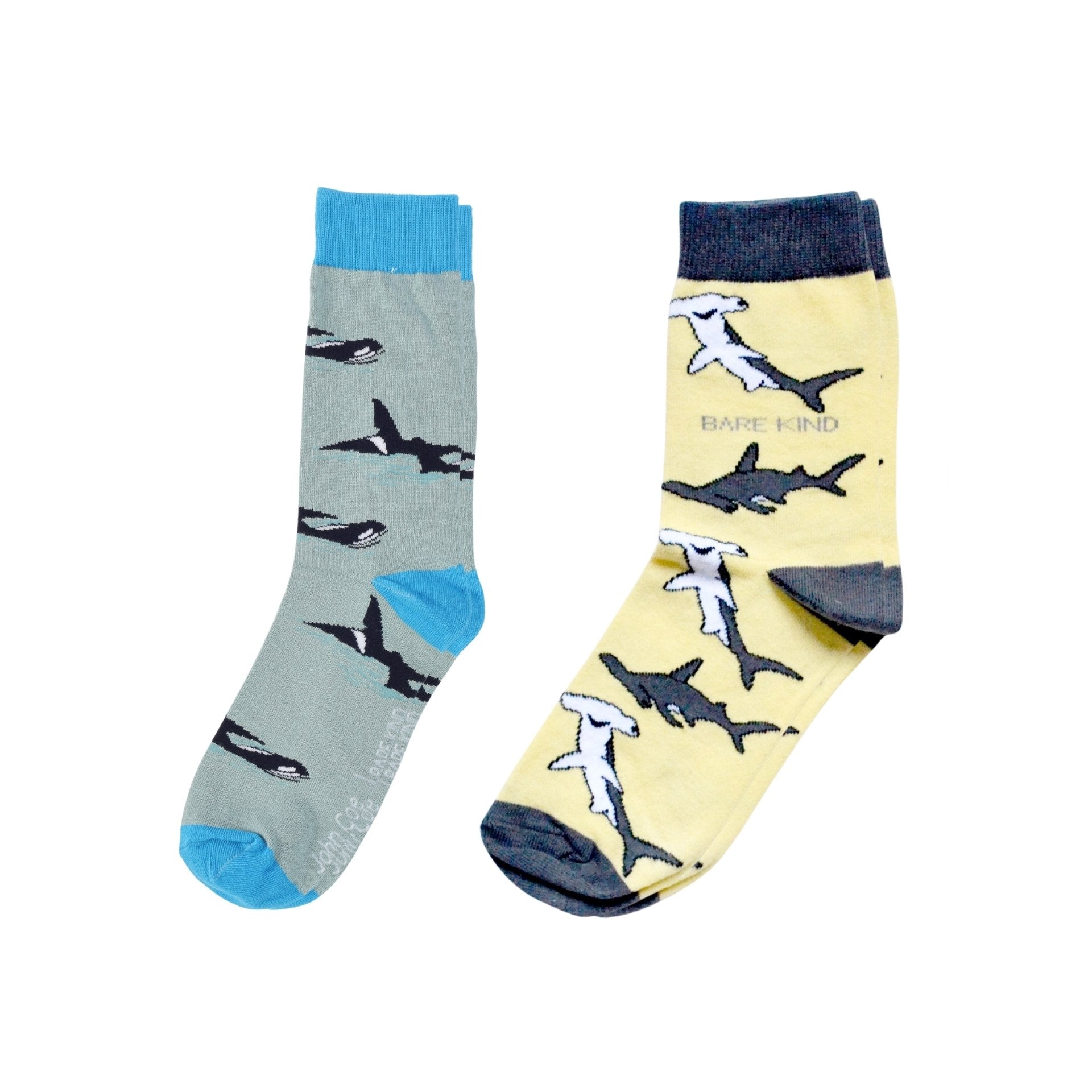 Two pairs of socks with shark  and orca designs on a white background