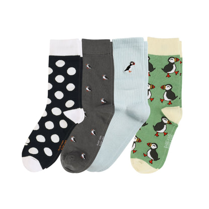 Four pairs of socks with different patterns on a white background